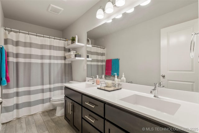 6605 S Elder Ave, Broken Arrow, OK 74011 - bathroom with wood finished floors, double vanity, and a shower with shower curtain
