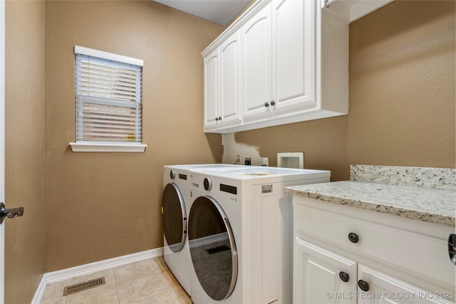 9722 S 75th E Ave, Tulsa, OK 74133 - laundry room with cabinet space, washing machine and dryer, and light tile patterned floors