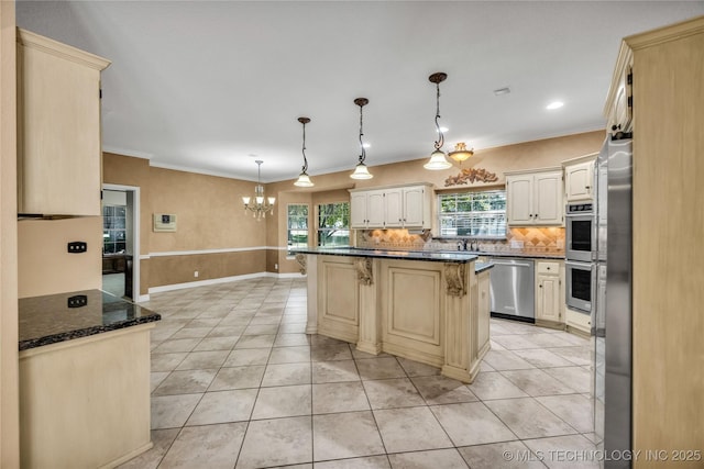 4405 Ithica St, Broken Arrow, OK 74012 - kitchen with stainless steel appliances, a kitchen bar, a chandelier, tasteful backsplash, and light tile patterned flooring