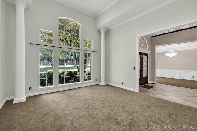 4405 Ithica St, Broken Arrow, OK 74012 - carpeted empty room with decorative columns, ornamental molding, a high ceiling, and tile patterned floors