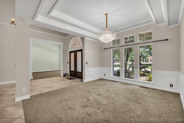 4405 Ithica St, Broken Arrow, OK 74012 - carpeted spare room with tile patterned floors, a chandelier, french doors, a wainscoted wall, and crown molding