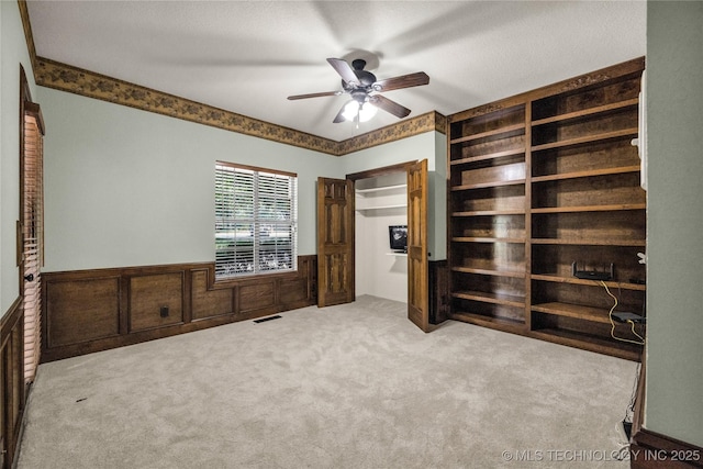4405 Ithica St, Broken Arrow, OK 74012 - unfurnished bedroom with wainscoting, carpet flooring, and ceiling fan