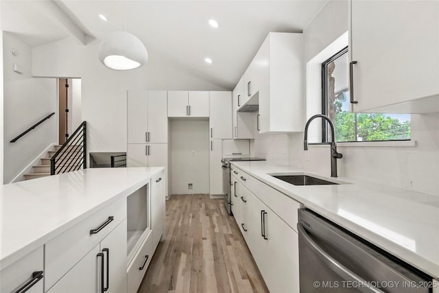 2936 E 75th St, Tulsa, OK 74136 - kitchen featuring appliances with stainless steel finishes, white cabinetry, lofted ceiling, light countertops, and light wood-style flooring