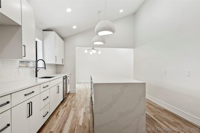 2936 E 75th St, Tulsa, OK 74136 - kitchen featuring light wood-type flooring, white cabinets, recessed lighting, hanging light fixtures, and lofted ceiling