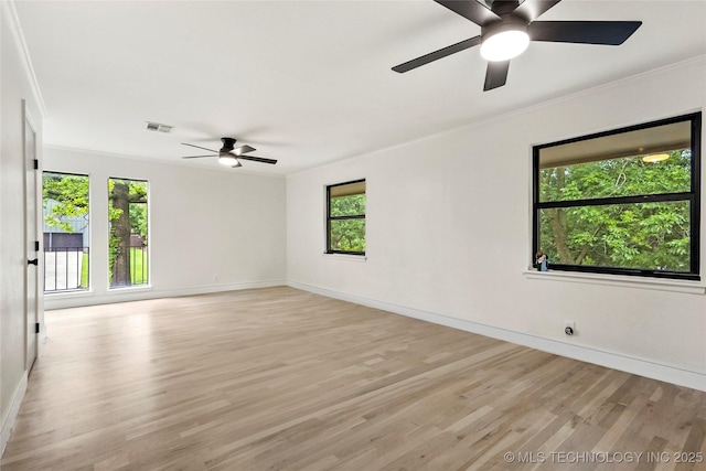 2936 E 75th St, Tulsa, OK 74136 - empty room with ceiling fan, plenty of natural light, ornamental molding, and light wood-style flooring
