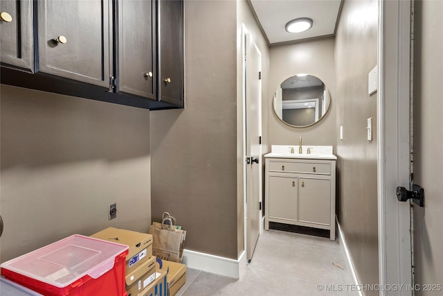2936 E 75th St, Tulsa, OK 74136 - laundry room with baseboards and light tile patterned floors