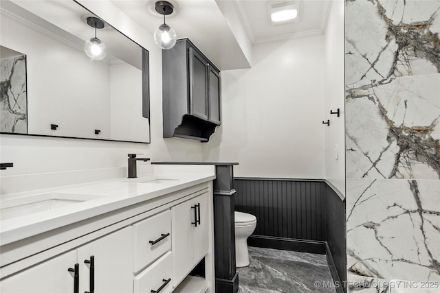 2936 E 75th St, Tulsa, OK 74136 - full bathroom featuring double vanity, marble tiled flooring, wainscoting, and crown molding