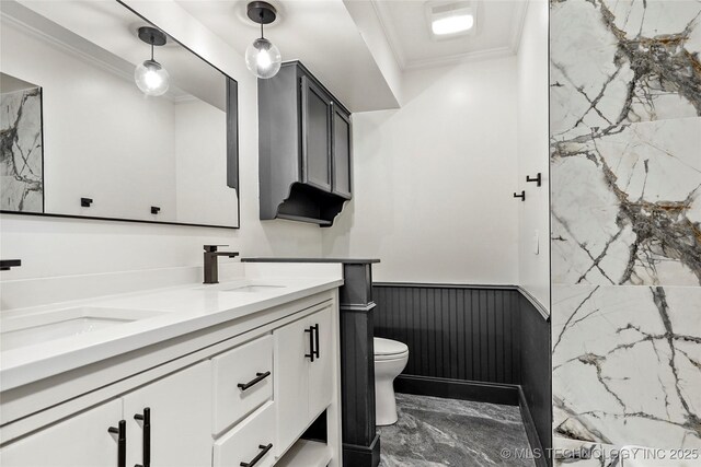 2936 E 75th St, Tulsa, OK 74136 - full bath with double vanity, marble tiled floors, wainscoting, and ornamental molding