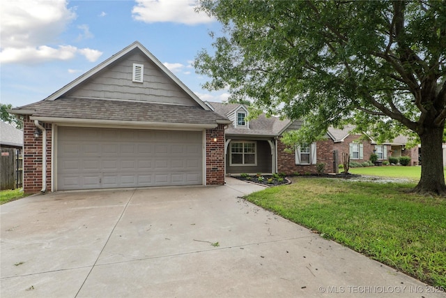 2110 S Javine Ct, Skiatook, OK 74070 - view of front of home with driveway, brick siding, a front yard, a garage, and a shingled roof
