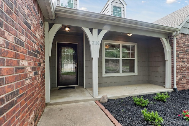 2110 S Javine Ct, Skiatook, OK 74070 - doorway to property featuring brick siding and a porch