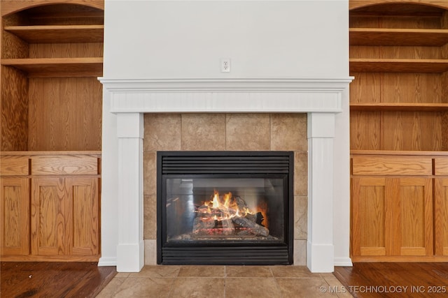 2110 S Javine Ct, Skiatook, OK 74070 - detailed view of a tile fireplace and wood finished floors