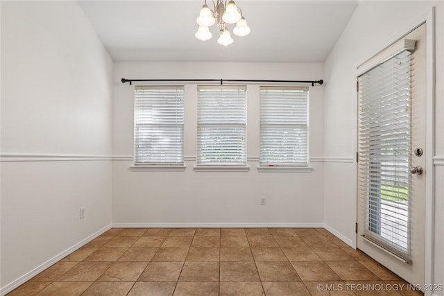 2110 S Javine Ct, Skiatook, OK 74070 - empty room featuring a chandelier, plenty of natural light, and light tile patterned floors