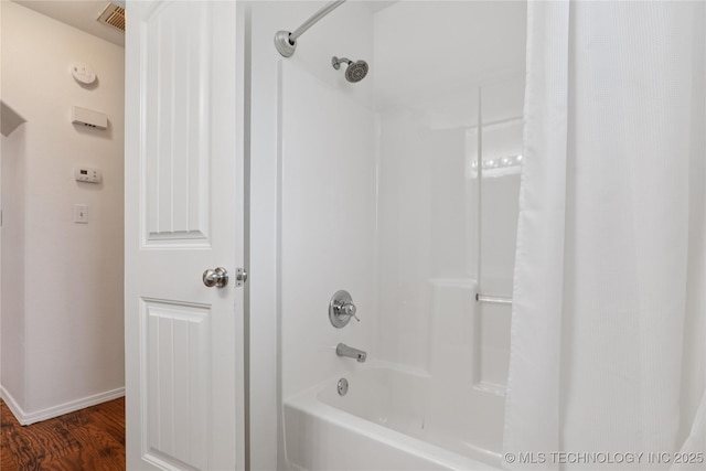 2110 S Javine Ct, Skiatook, OK 74070 - bathroom with wood finished floors and shower / bath combo with shower curtain