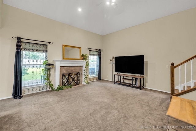 7416 S 109th E Ave, Tulsa, OK 74133 - carpeted living area featuring healthy amount of natural light, stairs, a tile fireplace, and a towering ceiling