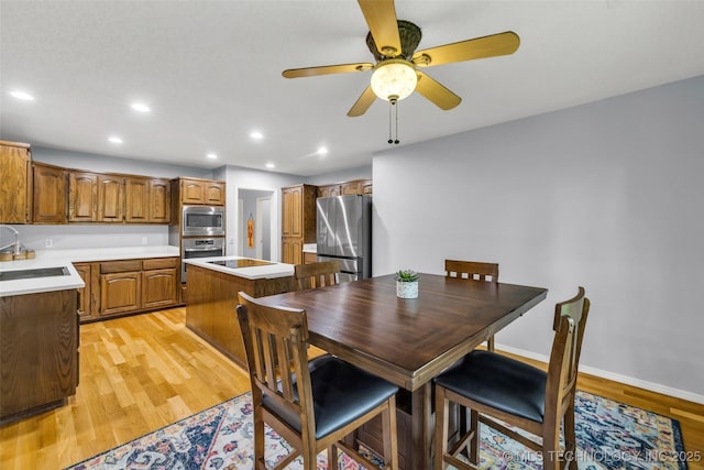 7416 S 109th E Ave, Tulsa, OK 74133 - dining area with light wood finished floors, a ceiling fan, and recessed lighting