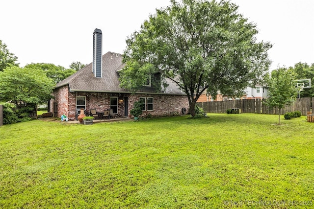 7416 S 109th E Ave, Tulsa, OK 74133 - rear view of property featuring a patio area, brick siding, a shingled roof, and a chimney