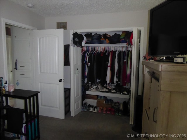 2414 S 126th E Ave, Tulsa, OK 74129 - bedroom featuring a closet, a textured ceiling, and carpet flooring