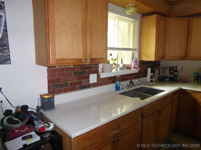 2414 S 126th E Ave, Tulsa, OK 74129 - kitchen featuring decorative backsplash and brown cabinets