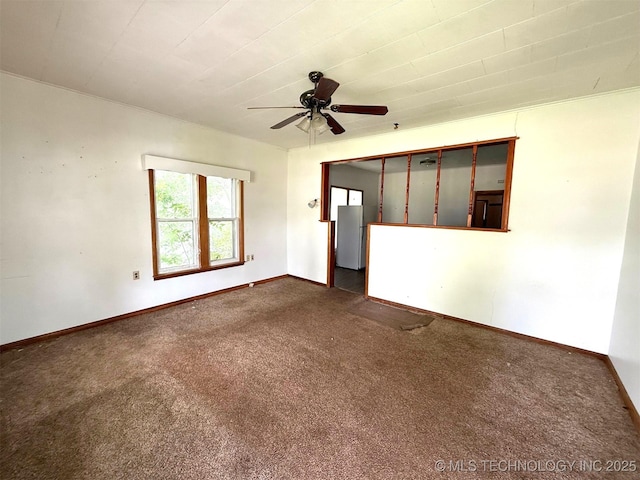 903 W Broadway St, Henryetta, OK 74437 - unfurnished room featuring dark carpet and a ceiling fan