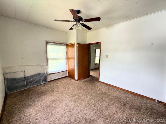 903 W Broadway St, Henryetta, OK 74437 - unfurnished bedroom featuring carpet, ornamental molding, and a ceiling fan