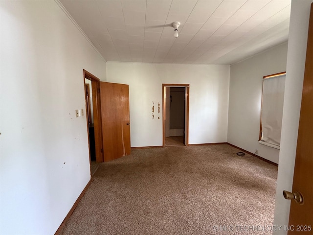 903 W Broadway St, Henryetta, OK 74437 - unfurnished bedroom featuring carpet floors and crown molding