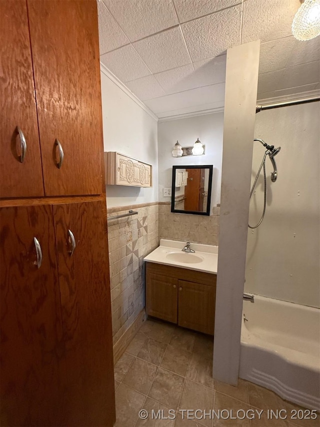 903 W Broadway St, Henryetta, OK 74437 - bathroom with vanity, ornamental molding, tile patterned flooring, tile walls, and a wainscoted wall