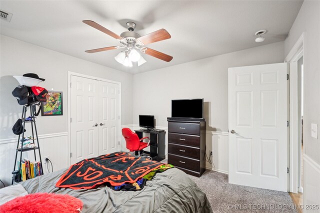 14220 S Vandalia Ave, Bixby, OK 74008 - bedroom featuring carpet, ceiling fan, a closet, and wainscoting
