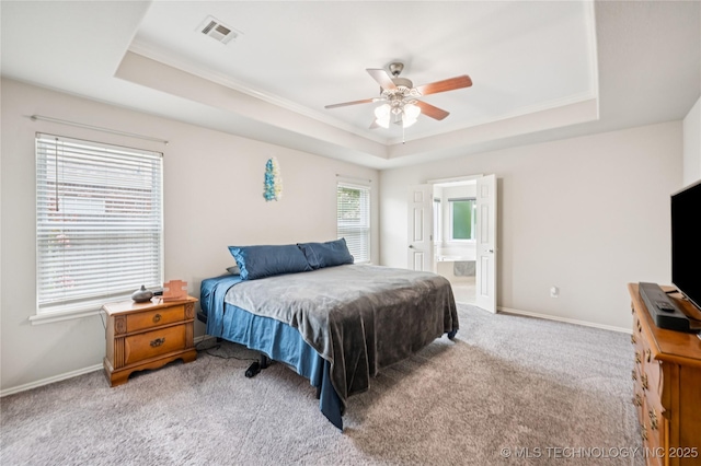 14220 S Vandalia Ave, Bixby, OK 74008 - carpeted bedroom featuring a tray ceiling, ornamental molding, ensuite bath, and ceiling fan