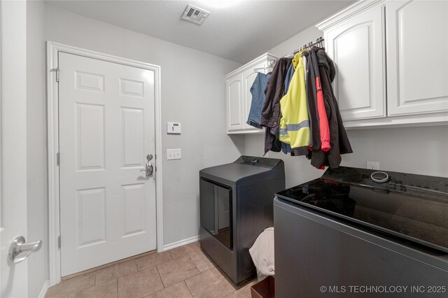 14220 S Vandalia Ave, Bixby, OK 74008 - washroom with washer and dryer, cabinet space, and light tile patterned flooring