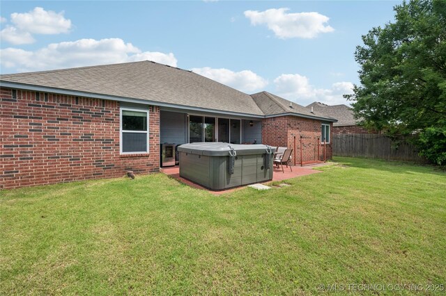 14220 S Vandalia Ave, Bixby, OK 74008 - back of house featuring a hot tub, brick siding, a shingled roof, and a patio area