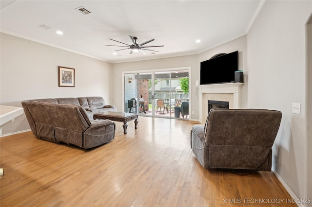 14220 S Vandalia Ave, Bixby, OK 74008 - living area with ceiling fan, crown molding, light wood-style flooring, a fireplace, and recessed lighting