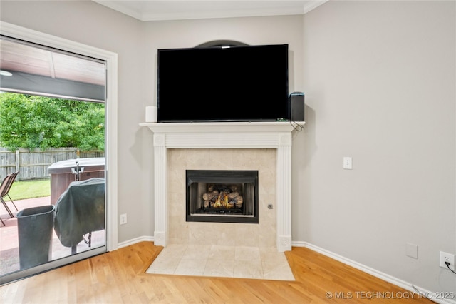 14220 S Vandalia Ave, Bixby, OK 74008 - detailed view of wood finished floors, a tiled fireplace, and ornamental molding