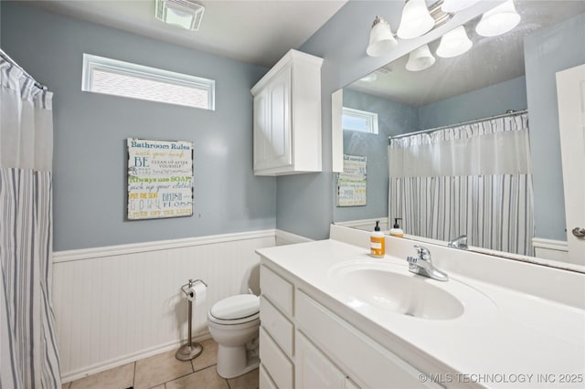 14220 S Vandalia Ave, Bixby, OK 74008 - bathroom featuring vanity, wainscoting, tile patterned flooring, and curtained shower