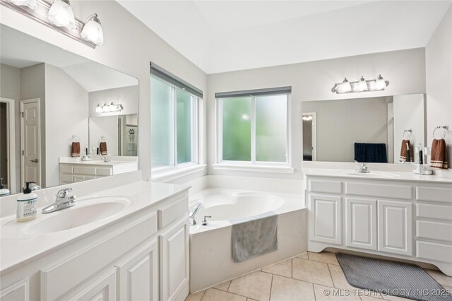 14220 S Vandalia Ave, Bixby, OK 74008 - bathroom with two vanities, a bath, and tile patterned floors