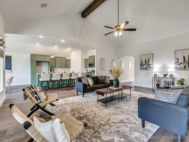 27742 E 109th St S, Coweta, OK 74429 - living room featuring arched walkways, ceiling fan, high vaulted ceiling, light wood finished floors, and beamed ceiling