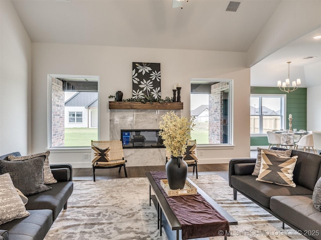 27742 E 109th St S, Coweta, OK 74429 - living area featuring a chandelier, wood finished floors, and a fireplace