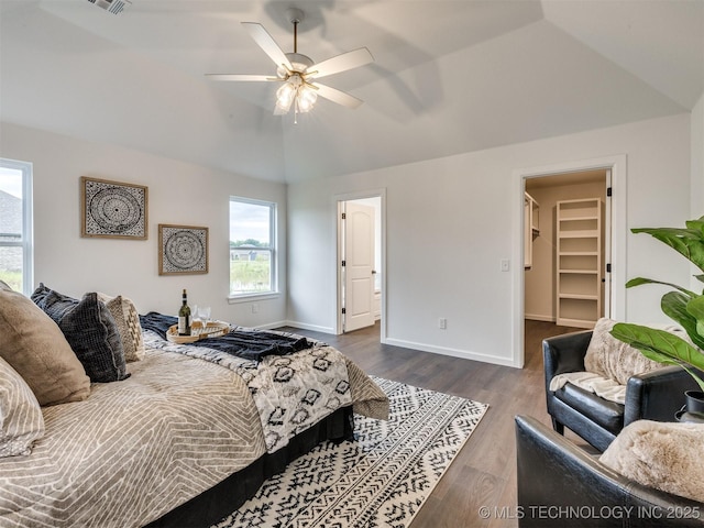 27742 E 109th St S, Coweta, OK 74429 - bedroom featuring vaulted ceiling, multiple windows, dark wood-style flooring, a spacious closet, and a ceiling fan