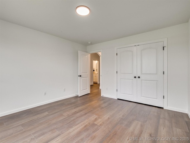 27742 E 109th St S, Coweta, OK 74429 - unfurnished bedroom with wood finished floors and a closet