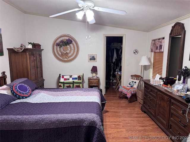 2399 County Road 1405, Skiatook, OK 74070 - bedroom featuring crown molding, light wood finished floors, lofted ceiling, ceiling fan, and a spacious closet