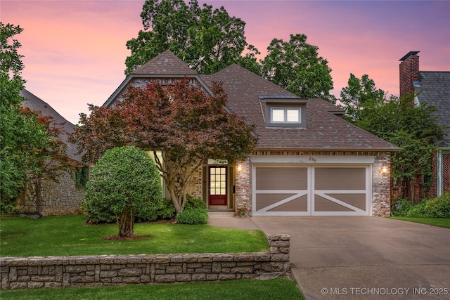 243 E 27th Pl, Tulsa, OK 74114 - view of front of house with driveway, a lawn, a shingled roof, and an attached garage