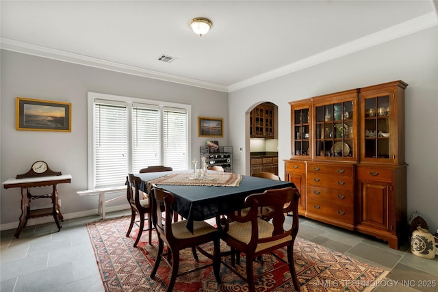243 E 27th Pl, Tulsa, OK 74114 - dining area featuring ornamental molding and arched walkways