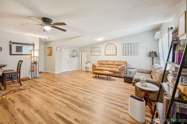 705 S E St, Skiatook, OK 74070 - living area with light wood-type flooring, a ceiling fan, a wall mounted air conditioner, and healthy amount of natural light