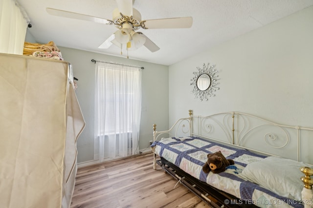 705 S E St, Skiatook, OK 74070 - bedroom featuring wood finished floors and ceiling fan