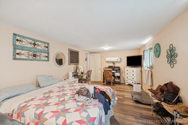 705 S E St, Skiatook, OK 74070 - bedroom featuring wood finished floors and a wall unit AC