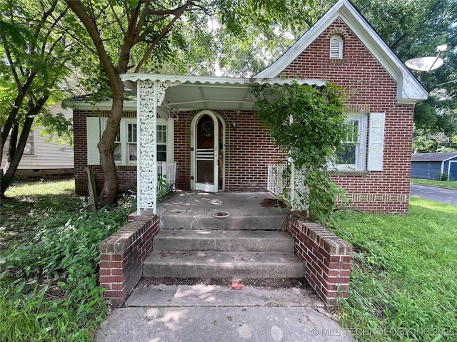 2102 Denver St, Muskogee, OK 74401 - view of front facade with brick siding and a porch