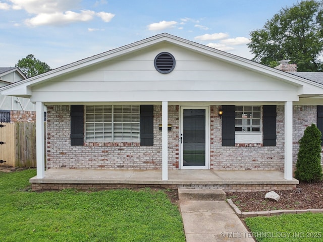 148 E 57th St, Tulsa, OK 74105 - view of front of house featuring covered porch and brick siding