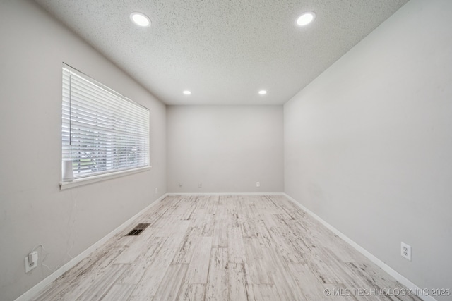 148 E 57th St, Tulsa, OK 74105 - spare room with recessed lighting, a textured ceiling, and wood finished floors