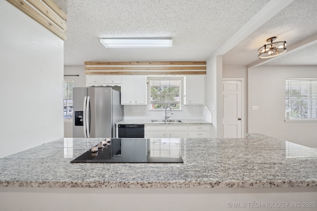 148 E 57th St, Tulsa, OK 74105 - kitchen featuring stainless steel fridge with ice dispenser, black electric cooktop, dishwasher, a textured ceiling, and white cabinets