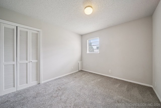 148 E 57th St, Tulsa, OK 74105 - unfurnished bedroom featuring carpet floors, a closet, and a textured ceiling