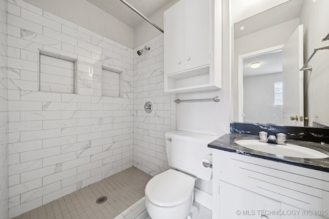148 E 57th St, Tulsa, OK 74105 - bathroom with a textured ceiling, a tile shower, and vanity